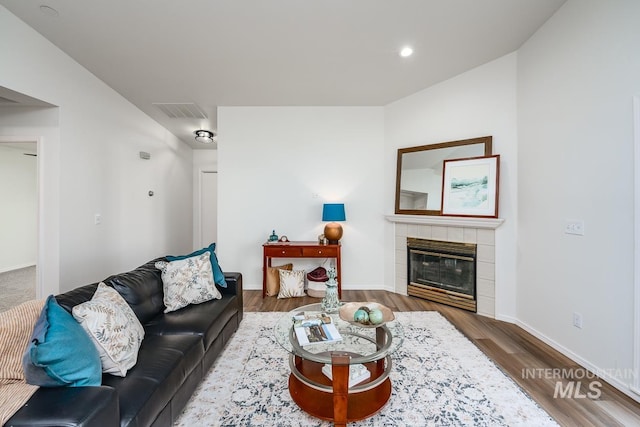 living room with dark hardwood / wood-style floors and a fireplace