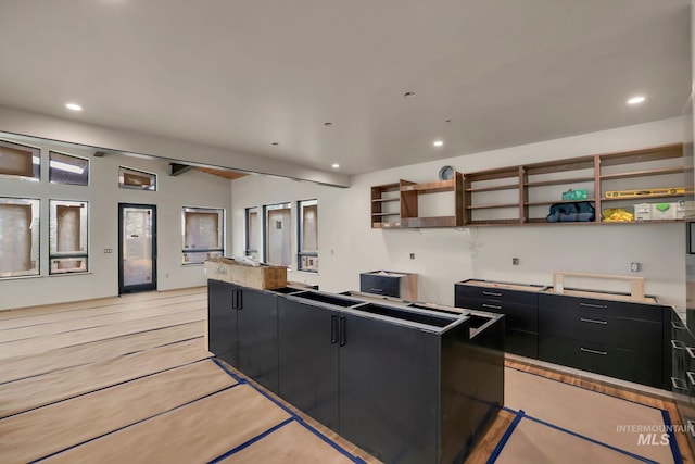 112 N Loop, New Meadows, ID 83654 - kitchen with dark cabinetry, open shelves, recessed lighting, and a center island