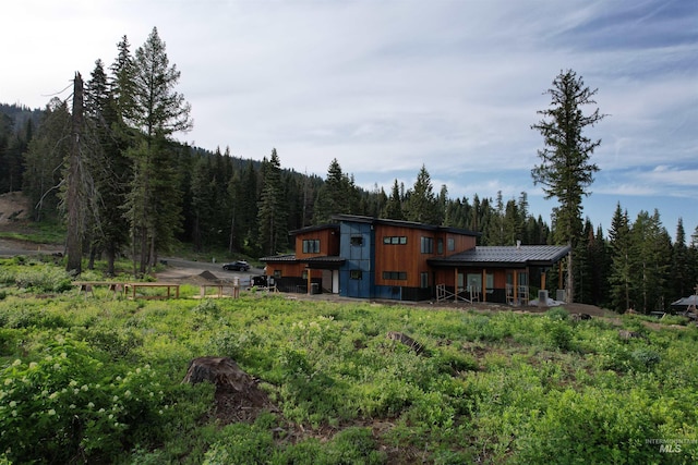 112 N Loop, New Meadows, ID 83654 - rear view of property featuring a wooded view and a metal roof