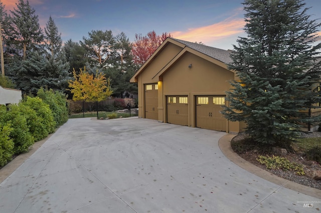 property exterior at dusk featuring a garage