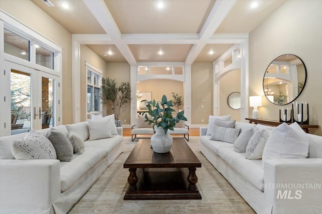 living room with beamed ceiling, coffered ceiling, and french doors