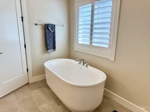2280 N Burnam Ave, Star, ID 83669 - bathroom featuring a freestanding tub, baseboards, and plenty of natural light