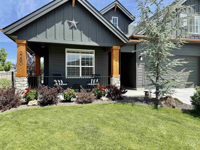2280 N Burnam Ave, Star, ID 83669 - view of front of home featuring board and batten siding, covered porch, a front yard, and a garage