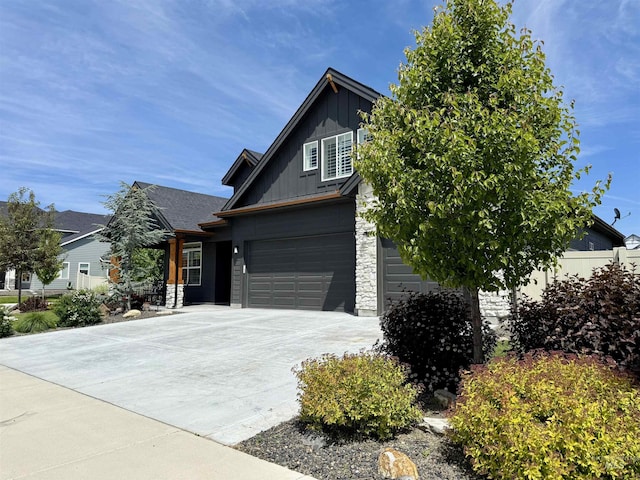 2280 N Burnam Ave, Star, ID 83669 - view of front of property with board and batten siding, driveway, an attached garage, and stone siding
