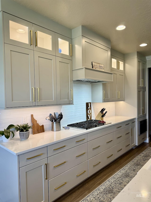 2280 N Burnam Ave, Star, ID 83669 - kitchen featuring stainless steel gas stovetop, dark wood-style floors, backsplash, glass insert cabinets, and recessed lighting