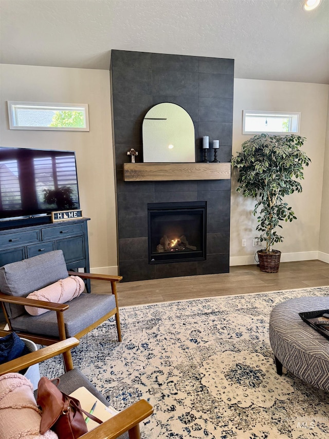 2280 N Burnam Ave, Star, ID 83669 - living room with baseboards, wood finished floors, a tile fireplace, healthy amount of natural light, and recessed lighting