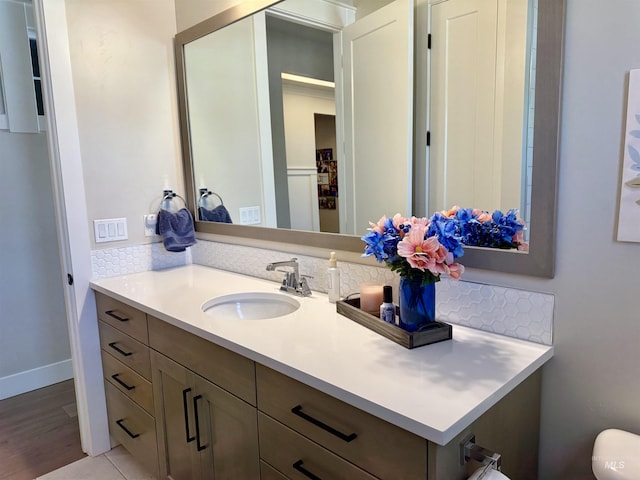 2280 N Burnam Ave, Star, ID 83669 - bathroom featuring vanity, baseboards, and wood finished floors