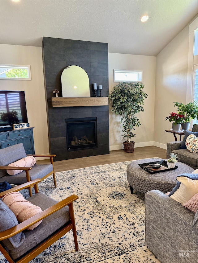 2280 N Burnam Ave, Star, ID 83669 - living room featuring plenty of natural light, a large fireplace, wood finished floors, baseboards, and recessed lighting
