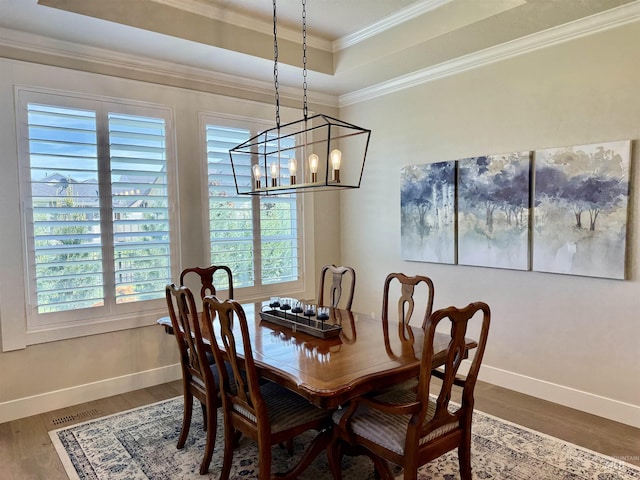 2280 N Burnam Ave, Star, ID 83669 - dining room with healthy amount of natural light, wood finished floors, a raised ceiling, a chandelier, and crown molding