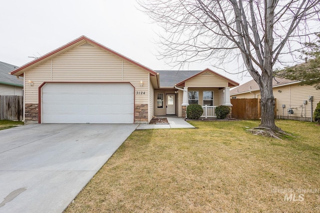 view of front of house featuring an attached garage, driveway, fence, and a front lawn