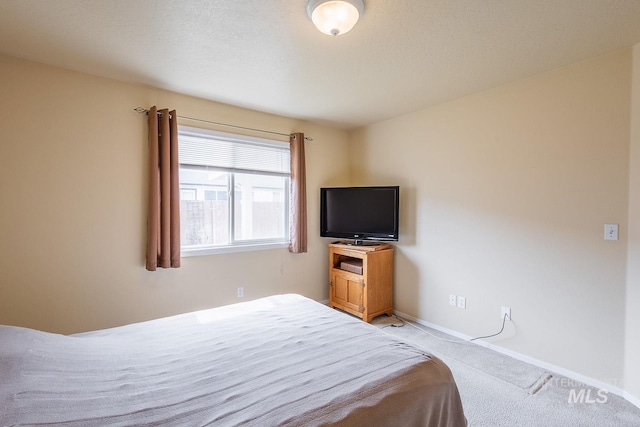 bedroom featuring carpet floors and baseboards