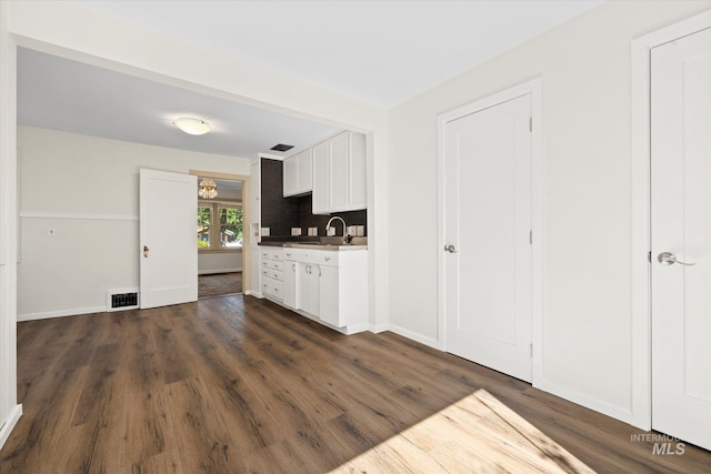 1806 N 28th St, Boise, ID 83703 - kitchen featuring a sink, dark wood-style floors, white cabinets, and baseboards