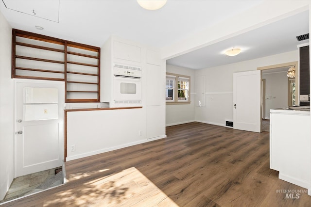 1806 N 28th St, Boise, ID 83703 - unfurnished living room with dark wood-type flooring and baseboards