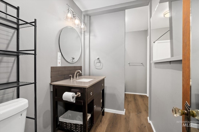 1806 N 28th St, Boise, ID 83703 - half bath featuring wood finished floors, baseboards, toilet, and vanity