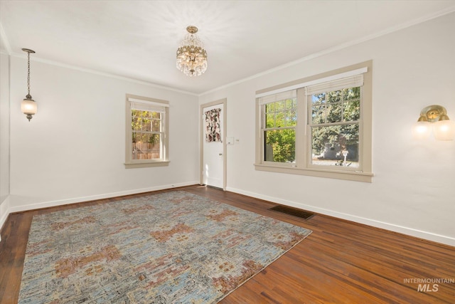 1806 N 28th St, Boise, ID 83703 - foyer featuring crown molding, baseboards, wood finished floors, and a chandelier