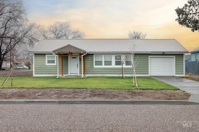 ranch-style house with a lawn and a garage