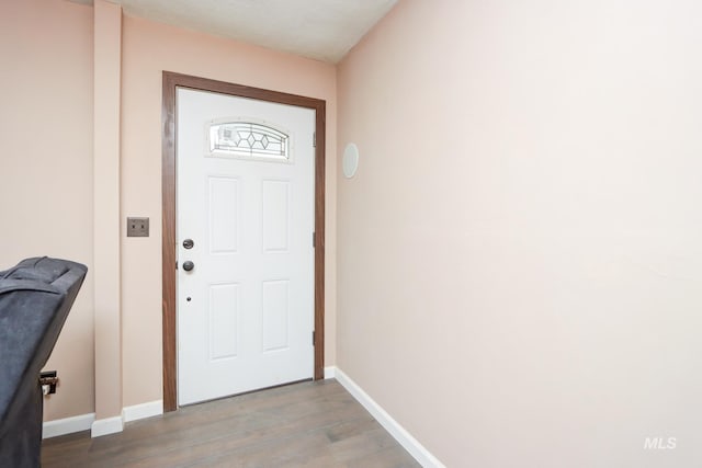 doorway with wood-type flooring and a textured ceiling