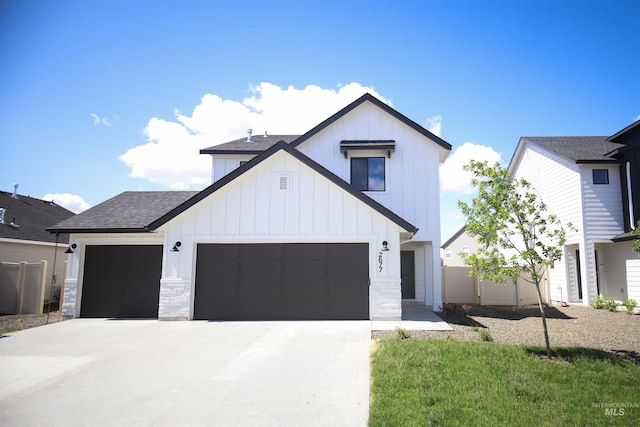 modern farmhouse style home featuring an attached garage, board and batten siding, and concrete driveway