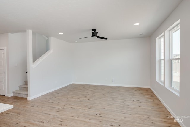 unfurnished room with light wood-style floors, recessed lighting, baseboards, and stairs