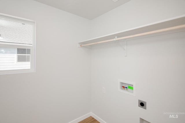 laundry room featuring washer hookup, hookup for an electric dryer, wood finished floors, laundry area, and baseboards