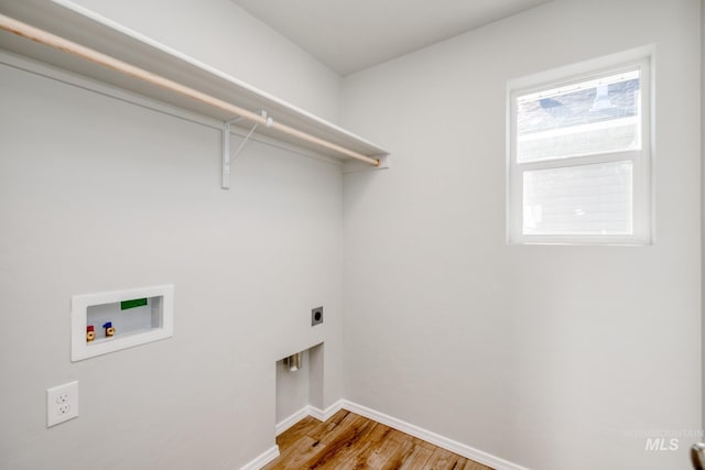 laundry room featuring washer hookup, light wood finished floors, hookup for an electric dryer, laundry area, and baseboards