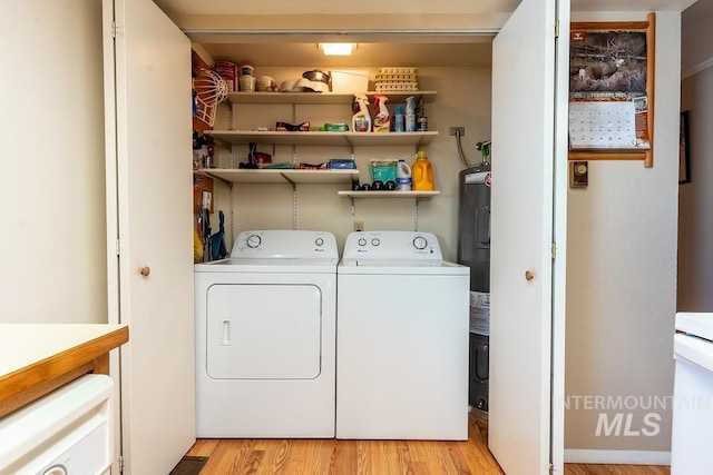 laundry area featuring light wood finished floors, laundry area, and washing machine and dryer