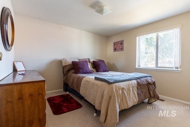 carpeted bedroom featuring baseboards