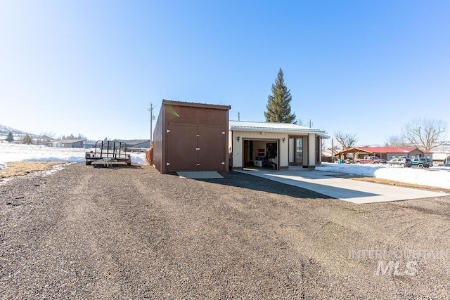 view of outbuilding with an attached garage and driveway