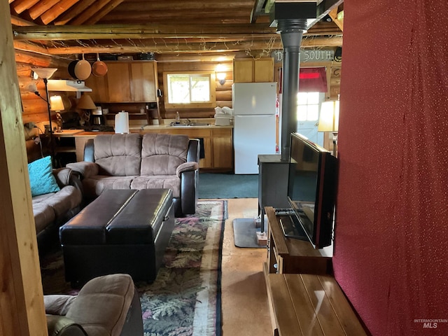2771 Dixie Rd, Dixie, ID 83525 - living room with log walls and concrete floors