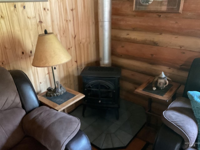 2771 Dixie Rd, Dixie, ID 83525 - sitting room with log walls, a wood stove, and tile patterned flooring