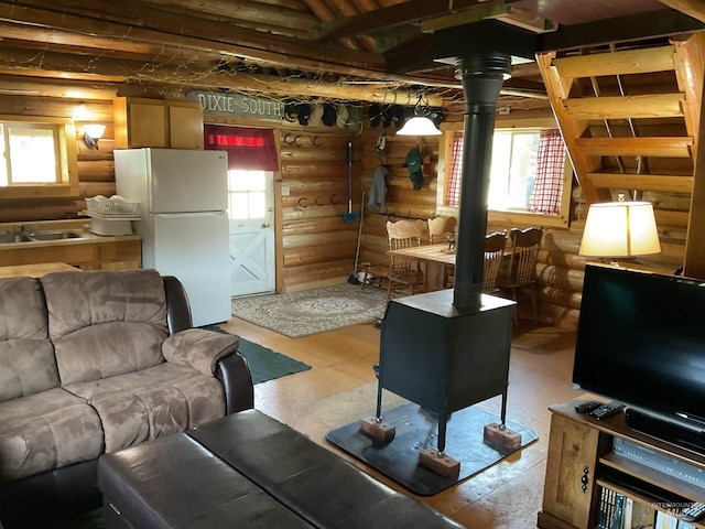 2771 Dixie Rd, Dixie, ID 83525 - living area featuring rustic walls, a wood stove, and light wood-style floors