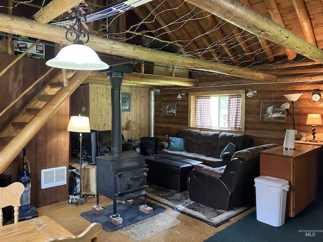 2771 Dixie Rd, Dixie, ID 83525 - living room featuring a wood stove, rustic walls, high vaulted ceiling, and beamed ceiling