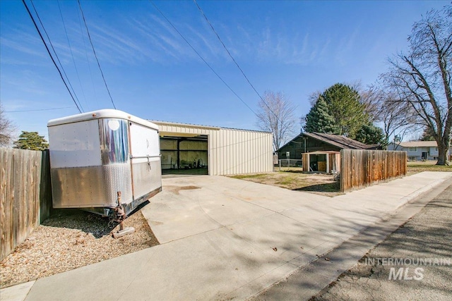 view of outdoor structure featuring an outbuilding and fence