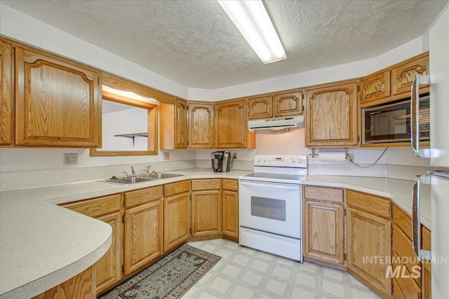 kitchen featuring black microwave, under cabinet range hood, light floors, light countertops, and electric range