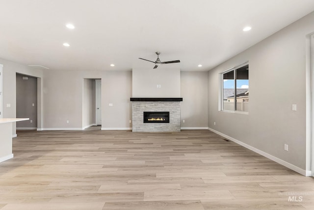 unfurnished living room with a ceiling fan, recessed lighting, light wood-style floors, and baseboards