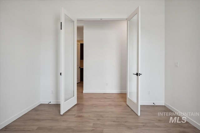 6139 W Burnt Sage Dr, Meridian, ID 83646 - unfurnished bedroom featuring light wood-style floors, french doors, and baseboards