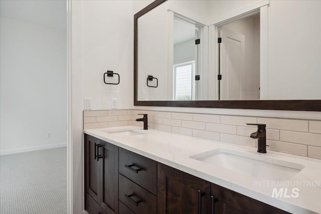 6139 W Burnt Sage Dr, Meridian, ID 83646 - bathroom with double vanity, a sink, and backsplash