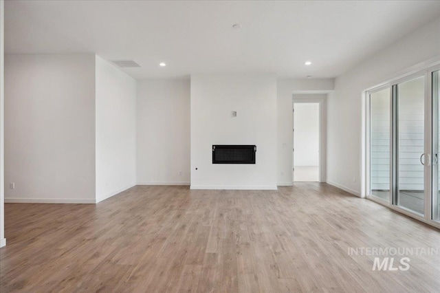 6139 W Burnt Sage Dr, Meridian, ID 83646 - unfurnished living room with light wood-style flooring, a fireplace, visible vents, and recessed lighting