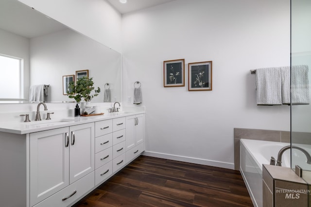 6139 W Burnt Sage Dr, Meridian, ID 83646 - full bathroom featuring wood finished floors, double vanity, a sink, and baseboards