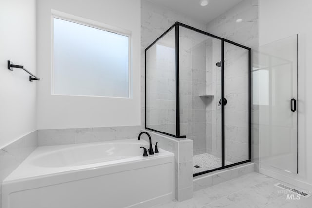9124 W Patmore Ct, Star, ID 83669 - bathroom with a garden tub, a stall shower, and marble finish flooring