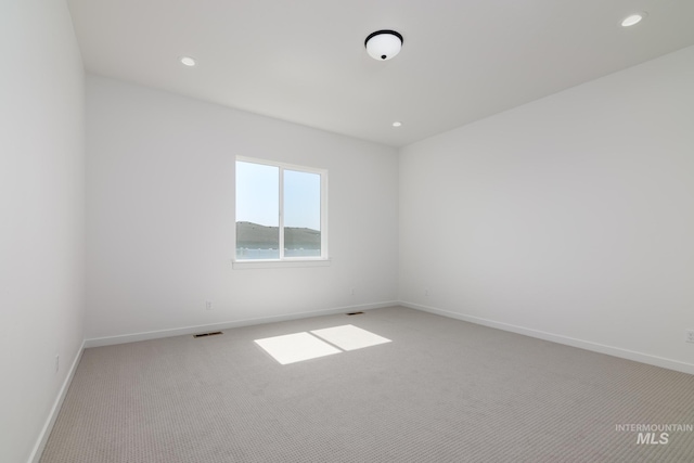 9124 W Patmore Ct, Star, ID 83669 - spare room with light colored carpet, baseboards, and recessed lighting