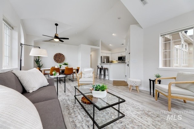 5158 S Surprise Way, Boise, ID 83716 - living room featuring lofted ceiling, ceiling fan, light wood-style floors, and baseboards