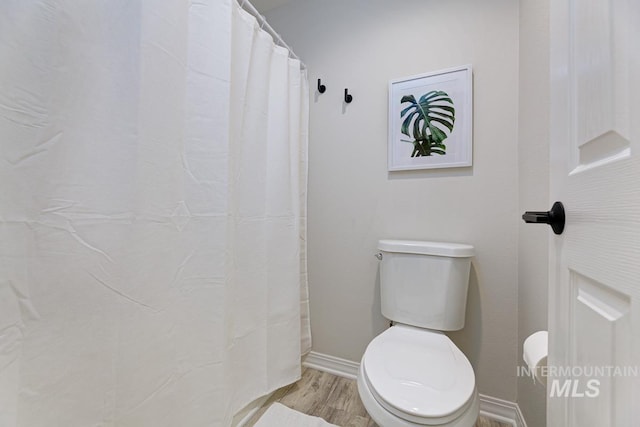 5158 S Surprise Way, Boise, ID 83716 - bathroom featuring wood finished floors, toilet, baseboards, and curtained shower