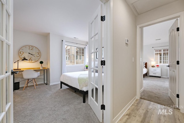 5158 S Surprise Way, Boise, ID 83716 - bedroom with french doors, light colored carpet, a desk, and baseboards