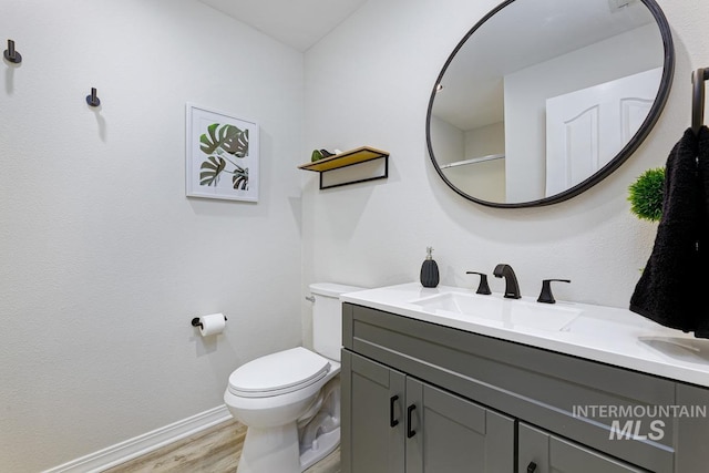 5158 S Surprise Way, Boise, ID 83716 - bathroom featuring wood finished floors, toilet, vanity, and baseboards