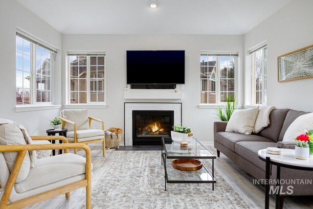 5158 S Surprise Way, Boise, ID 83716 - living room featuring wood finished floors and a tiled fireplace