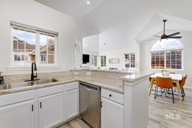 5158 S Surprise Way, Boise, ID 83716 - kitchen with stainless steel dishwasher, a sink, vaulted ceiling, light wood finished floors, and open floor plan