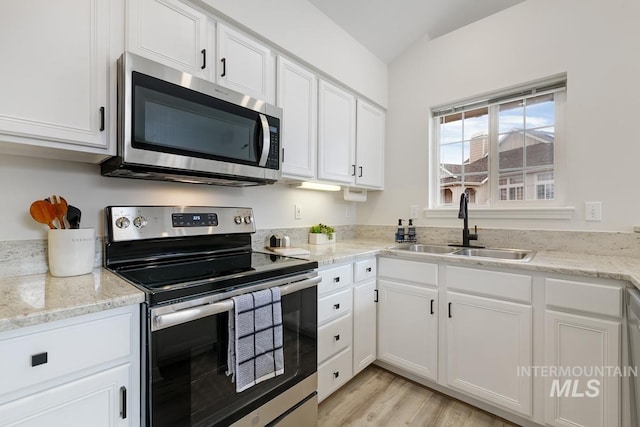 5158 S Surprise Way, Boise, ID 83716 - kitchen featuring stainless steel appliances, a sink, white cabinets, light wood-style flooring, and light stone counters
