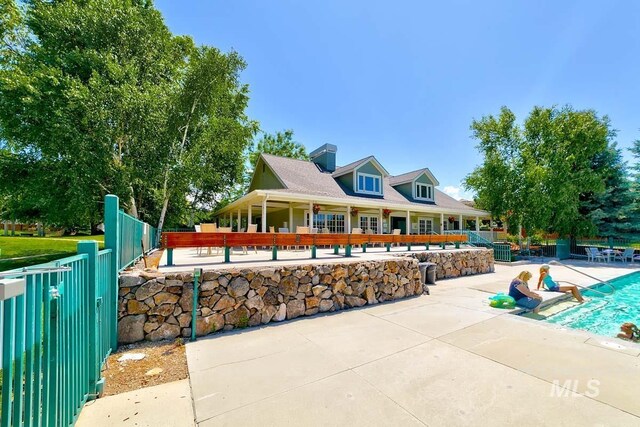 5158 S Surprise Way, Boise, ID 83716 - exterior space with fence, a patio, and a chimney