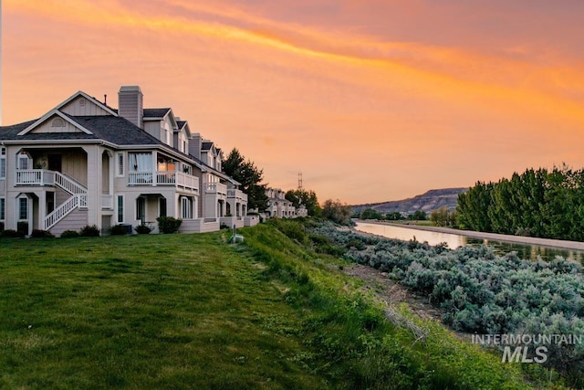 5158 S Surprise Way, Boise, ID 83716 - property exterior at dusk with a yard and a chimney